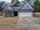 Cute blue house with a white garage door and a well-maintained lawn at 305 Pinecrest Rd, Mount Dora, FL 32757