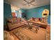 Living room with teal walls, hardwood floors, and comfy couches at 305 Pinecrest Rd, Mount Dora, FL 32757