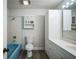 Bathroom with light blue bathtub, toilet and white vanity at 3045 Dove Ln, Mulberry, FL 33860