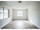Bright bedroom with large windows and wood-look floors at 3045 Dove Ln, Mulberry, FL 33860