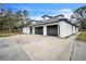 White brick home with a large gray three-car garage at 3045 Dove Ln, Mulberry, FL 33860