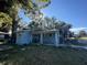 Blue house with significant tree damage to roof at 216 N Salem St, Eustis, FL 32726