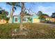 Charming teal house with a yellow garage door and landscaping at 3249 Lake Helen Osteen Rd, Deltona, FL 32738