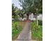 Small house with a walkway and overgrown yard at 4054 Columbia St, Orlando, FL 32811