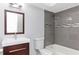 Updated bathroom with gray tile, modern vanity, and bathtub at 4539 Wild Rose Ct, Orlando, FL 32808