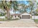 Single-story home featuring solar panels, a brick and stucco facade, and a spacious driveway at 4539 Wild Rose Ct, Orlando, FL 32808