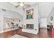 Cozy living room with a fireplace, ceiling fan, and an open floor plan, blending comfort and style at 4539 Wild Rose Ct, Orlando, FL 32808