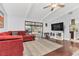 Bright living room featuring dark floors, a ceiling fan, and a view of the backyard at 4539 Wild Rose Ct, Orlando, FL 32808