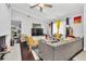 Comfortable living room featuring a vaulted ceiling, ceiling fan, and lots of natural light at 4539 Wild Rose Ct, Orlando, FL 32808