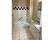 Condo bathroom with granite countertop and black and white tile floors at 705 Celebration Ave # 705, Celebration, FL 34747