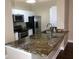 Modern condo kitchen with granite countertops and stainless steel appliances at 705 Celebration Ave # 705, Celebration, FL 34747