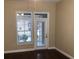 Condo living room with hardwood floors and French doors leading to a patio at 705 Celebration Ave # 705, Celebration, FL 34747