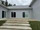 Concrete patio with stairs leading to the backyard at 9805 Sw 44Th Ter, Ocala, FL 34476