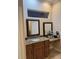 Elegant bathroom with granite vanity and large mirrors at 1150 Sweet Heather Ln, Apopka, FL 32712