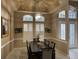 Formal dining room features a dark wood table and marble floors at 1150 Sweet Heather Ln, Apopka, FL 32712