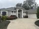 Two-story house with a gray facade, a three-car garage, and landscaping at 1150 Sweet Heather Ln, Apopka, FL 32712