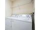 Practical laundry area with a washer, dryer, and wire rack at 301 New Providence Promenade, Davenport, FL 33897