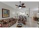 Cozy living room featuring comfortable seating, stylish decor, and an open layout flowing into the kitchen at 301 New Providence Promenade, Davenport, FL 33897