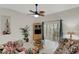 Inviting living room with tiled floors, large sliding glass doors to the screened patio, and ceiling fan at 301 New Providence Promenade, Davenport, FL 33897