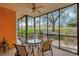 Relaxing screened patio with views of the backyard and landscaping, offering a serene outdoor seating area at 301 New Providence Promenade, Davenport, FL 33897