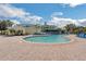 Community pool surrounded by lounge chairs with the clubhouse visible in the background at 301 New Providence Promenade, Davenport, FL 33897