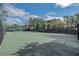 A community tennis court surrounded by trees and landscaping at 301 New Providence Promenade, Davenport, FL 33897