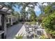 An outdoor patio with various seating arrangements, and covered grill, surrounded by well maintained landscaping at 4503 Se 14Th St, Ocala, FL 34471