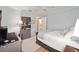 Neutral bedroom featuring carpet flooring, ceiling fan, desk, and an ensuite bathroom at 4503 Se 14Th St, Ocala, FL 34471