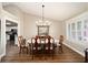 Spacious dining room boasts hardwood floors, a white table with seating for six, and natural light at 4503 Se 14Th St, Ocala, FL 34471