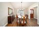 Dining room features a white table, elegant chandelier, and hardwood floors at 4503 Se 14Th St, Ocala, FL 34471