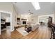 Cozy living room featuring hardwood floors, a skylight, and a white brick fireplace at 4503 Se 14Th St, Ocala, FL 34471