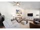 Comfortable living room with carpet, a ceiling fan, neutral paint, and unique decor at 4503 Se 14Th St, Ocala, FL 34471