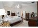 Main bedroom with hardwood floors, ceiling fan, and an ensuite bathroom at 4503 Se 14Th St, Ocala, FL 34471