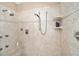 Tiled walk-in shower with multiple shower heads, built-in seat, and neutral colors at 4503 Se 14Th St, Ocala, FL 34471