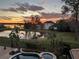 Evening aerial view of backyard pool, lake, and neighborhood homes at 889 Brantley Dr, Longwood, FL 32779