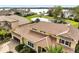 Stunning aerial view of the home highlighting the terra cotta tile roof and picturesque pond with fountain and lake views at 889 Brantley Dr, Longwood, FL 32779