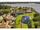 Aerial view of a lakeside property with a pool, a pond with a fountain, and mature trees at 889 Brantley Dr, Longwood, FL 32779