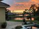 A backyard view overlooking the lake with a serene pool and outdoor seating, perfect for evening relaxation at 889 Brantley Dr, Longwood, FL 32779