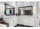 Bright bathroom featuring double vanity sinks with marble countertops and large mirrors at 889 Brantley Dr, Longwood, FL 32779