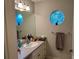 Bathroom boasts a vanity, large mirror, and a circular window at 889 Brantley Dr, Longwood, FL 32779