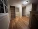 Bright hallway with wood floors and mirrored closet doors at 889 Brantley Dr, Longwood, FL 32779