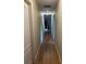 Long hallway with hardwood floors and multiple doors at 889 Brantley Dr, Longwood, FL 32779