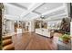 Open-concept living room with coffered ceiling, wood flooring, comfortable seating and views of the kitchen at 889 Brantley Dr, Longwood, FL 32779