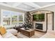 Cozy living room featuring a stone fireplace, built-in cabinets and plantation shutters for natural light at 889 Brantley Dr, Longwood, FL 32779