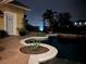 Elegant outdoor pool area at night with serene fountain views, lush landscaping, and ambient string lighting at 889 Brantley Dr, Longwood, FL 32779