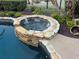 Stone spa nestled in landscaped backyard; water feature at 889 Brantley Dr, Longwood, FL 32779