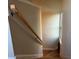 Light-filled staircase with wooden handrail and hardwood floors at 889 Brantley Dr, Longwood, FL 32779