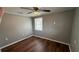 Bedroom with hardwood floors and two windows at 11331 Northern Ave, Leesburg, FL 34788