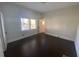 Bright bedroom featuring dark hardwood floors and large windows at 373 E Waldo St, Groveland, FL 34736