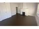 Bright bedroom with dark hardwood floors and a white fireplace at 373 E Waldo St, Groveland, FL 34736